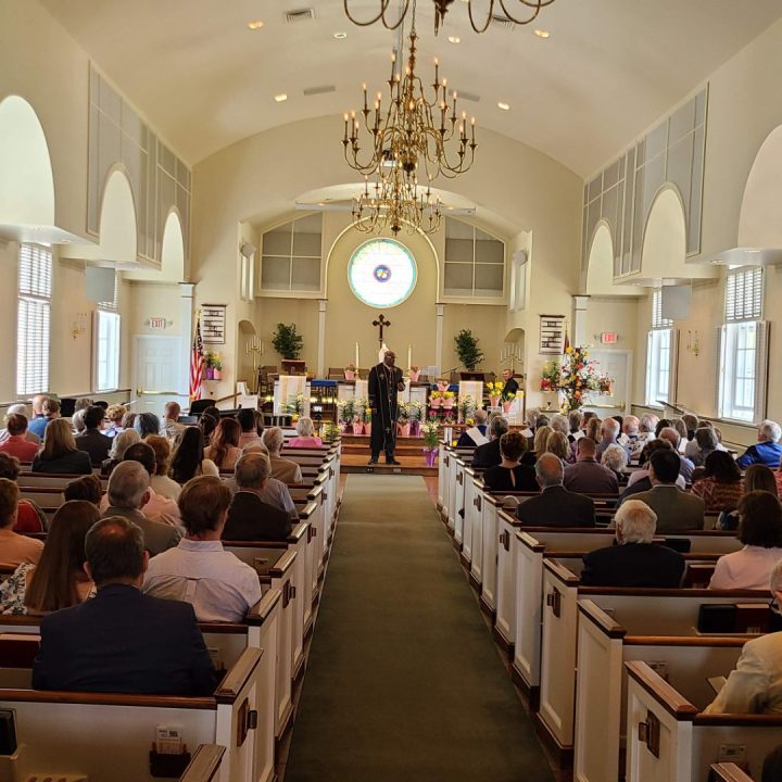 Sanctuary with Pastor preaching and full pews